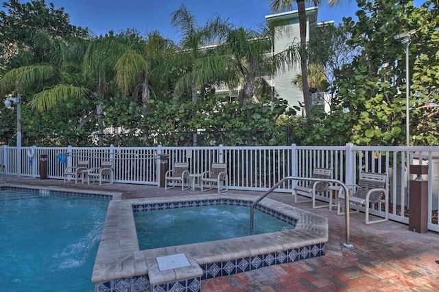 view of swimming pool with an in ground hot tub and a patio area