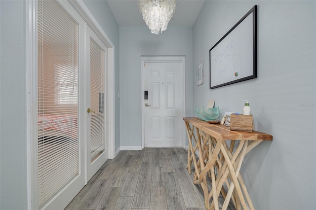 530 S Gulfview Blvd Unit 205, Clearwater, FL 33767 - entrance foyer with wood finished floors and a chandelier