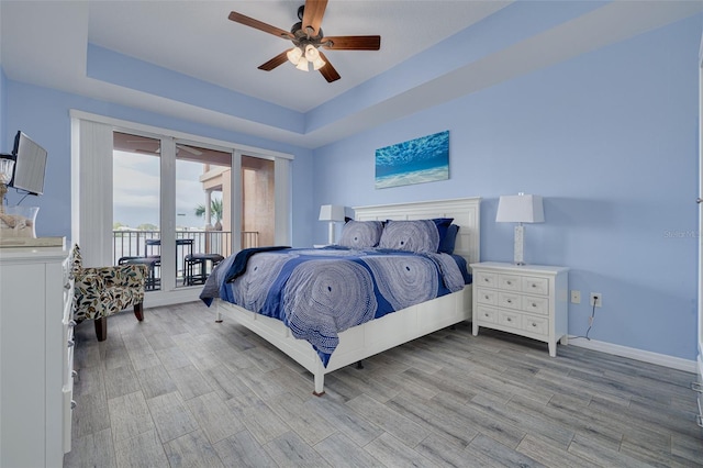 530 S Gulfview Blvd Unit 205, Clearwater, FL 33767 - bedroom featuring a raised ceiling, access to outside, light wood-style floors, and ceiling fan