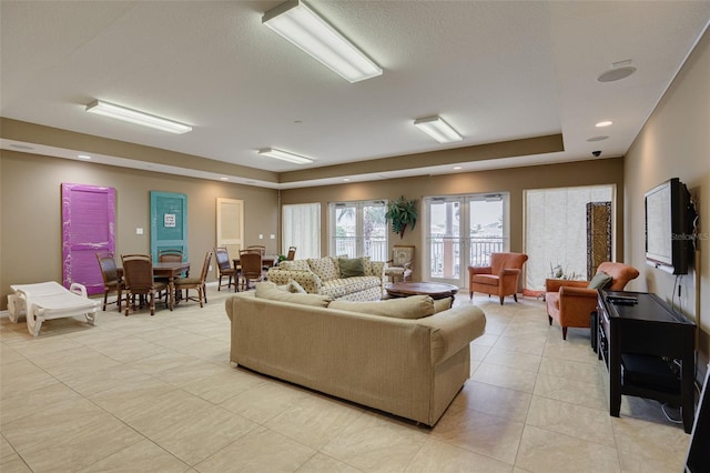 530 S Gulfview Blvd Unit 205, Clearwater, FL 33767 - living area featuring light tile patterned floors and a tray ceiling