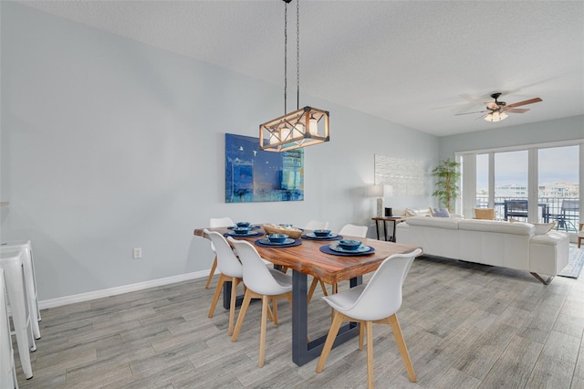 530 S Gulfview Blvd Unit 205, Clearwater, FL 33767 - dining area featuring light wood-type flooring, ceiling fan, and a textured ceiling
