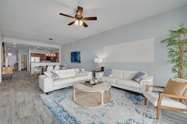 530 S Gulfview Blvd Unit 205, Clearwater, FL 33767 - living area featuring ceiling fan, light wood finished floors, and a chandelier