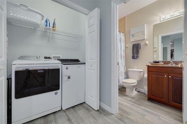 530 S Gulfview Blvd Unit 205, Clearwater, FL 33767 - laundry area with washing machine and clothes dryer and light wood-style floors