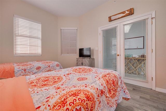 530 S Gulfview Blvd Unit 205, Clearwater, FL 33767 - bedroom with access to exterior and wood finished floors