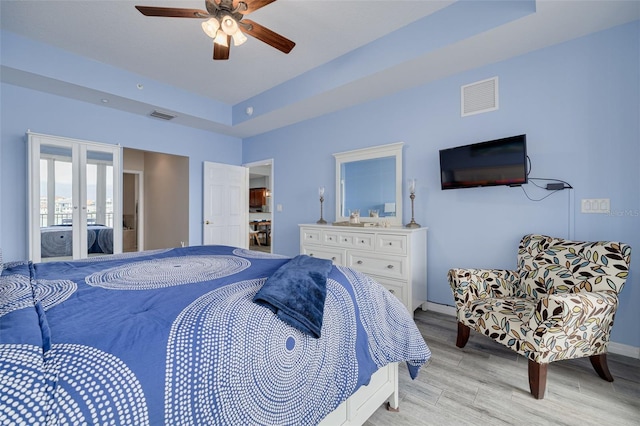 530 S Gulfview Blvd Unit 205, Clearwater, FL 33767 - bedroom featuring french doors, light wood-style floors, and a ceiling fan