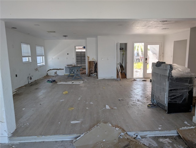 unfurnished living room featuring french doors