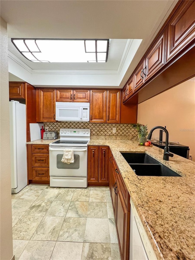 kitchen featuring white appliances, crown molding, light stone counters, decorative backsplash, and sink