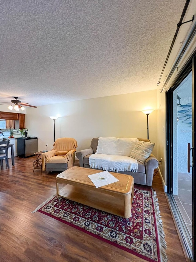 living room featuring a textured ceiling, a wealth of natural light, and hardwood / wood-style flooring