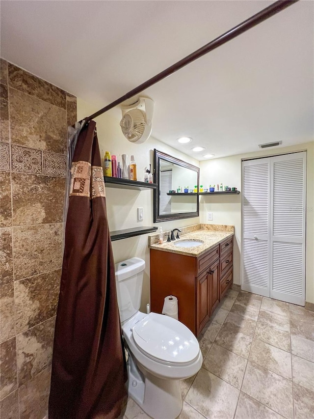 bathroom with toilet and vanity