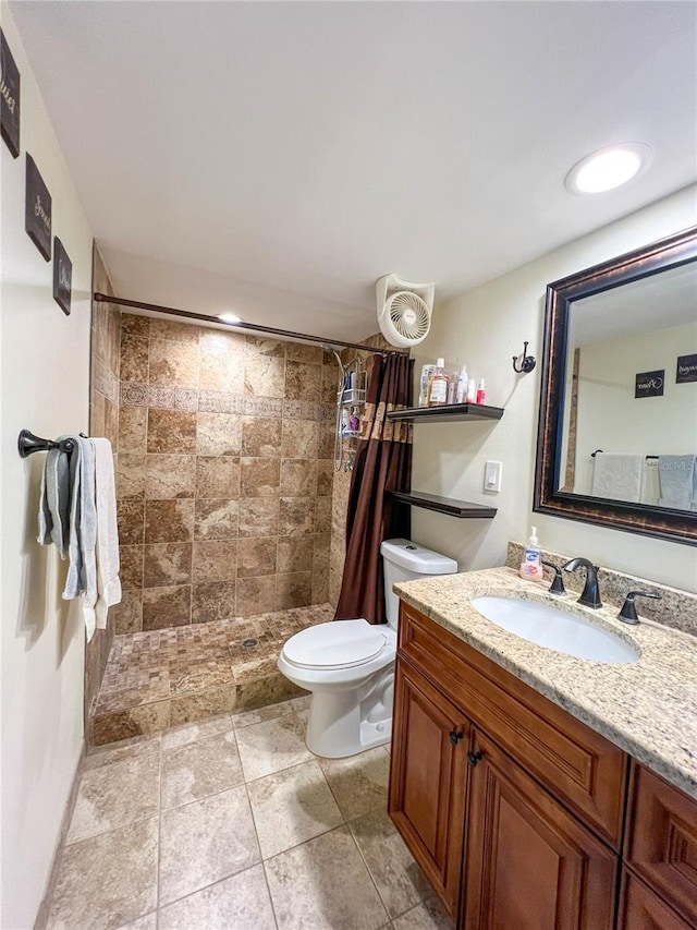 bathroom with curtained shower, vanity, and toilet