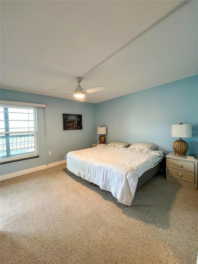 bedroom with ceiling fan and carpet