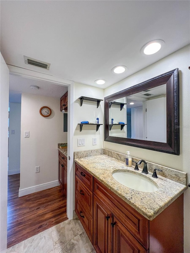 bathroom with vanity and hardwood / wood-style flooring