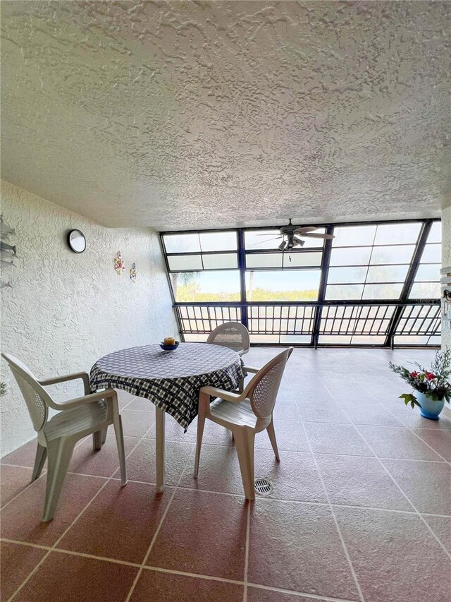 dining space featuring a wall of windows