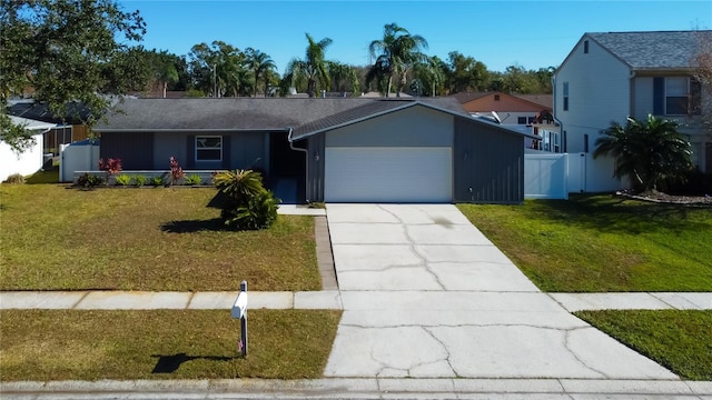 view of front of house with a front yard and a garage