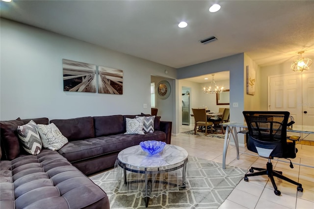 tiled living room with an inviting chandelier