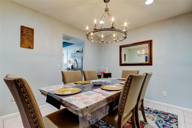 dining space with an inviting chandelier and light tile patterned floors