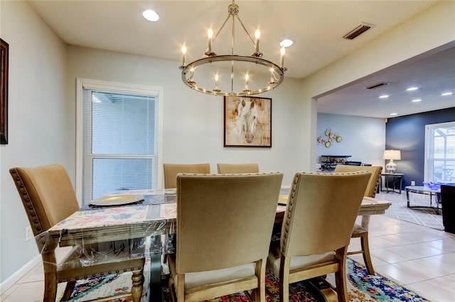 tiled dining area with a chandelier