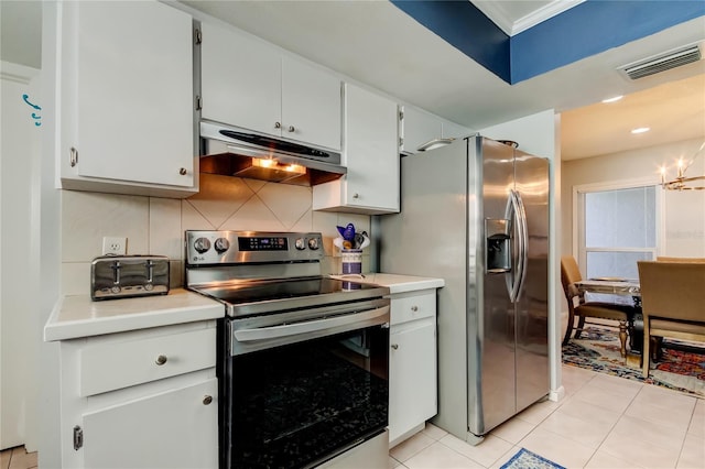 kitchen featuring stainless steel appliances, light tile patterned flooring, decorative backsplash, and white cabinetry