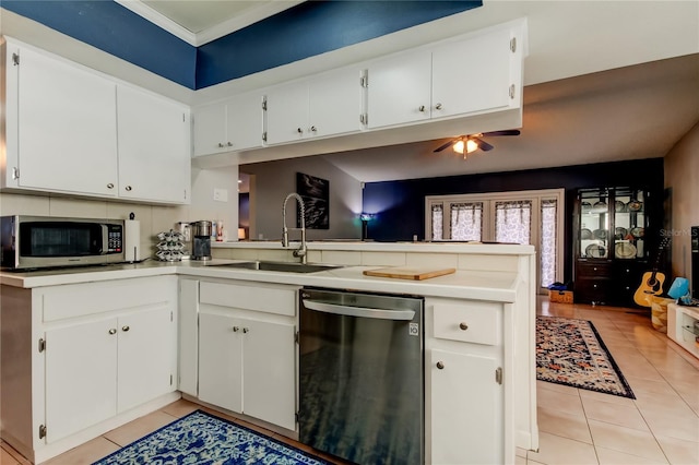 kitchen with kitchen peninsula, dishwasher, white cabinets, and sink