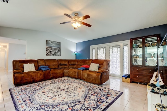 tiled living room with lofted ceiling and ceiling fan