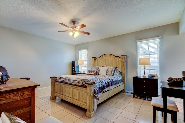 tiled bedroom featuring ceiling fan and a textured ceiling