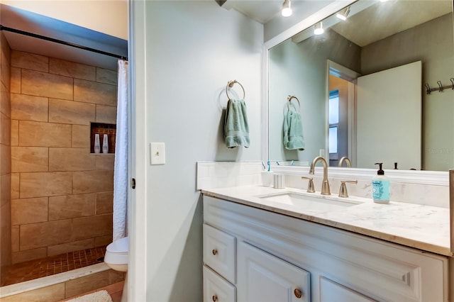 bathroom with a shower with shower curtain, tile patterned floors, vanity, and toilet