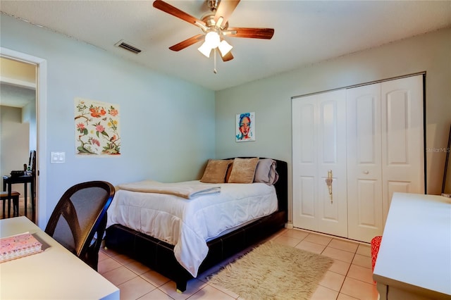 tiled bedroom with a closet and ceiling fan