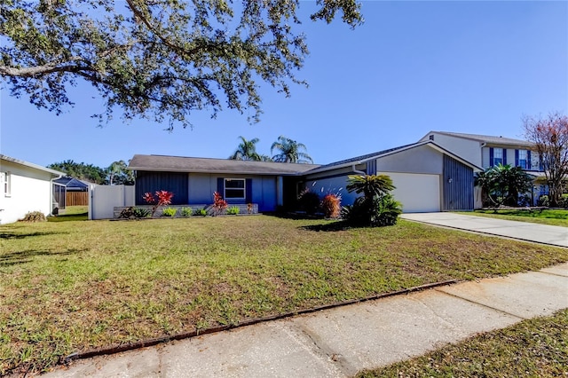 ranch-style home with a front yard and a garage