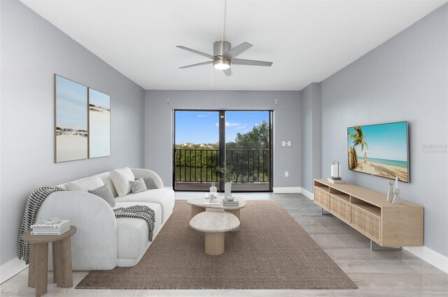 living room featuring ceiling fan and hardwood / wood-style floors