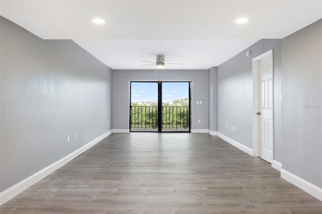 unfurnished room featuring ceiling fan and hardwood / wood-style flooring