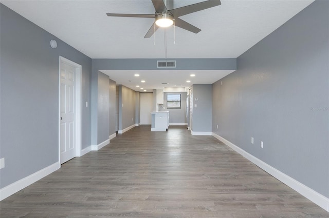 unfurnished living room featuring ceiling fan and light hardwood / wood-style flooring