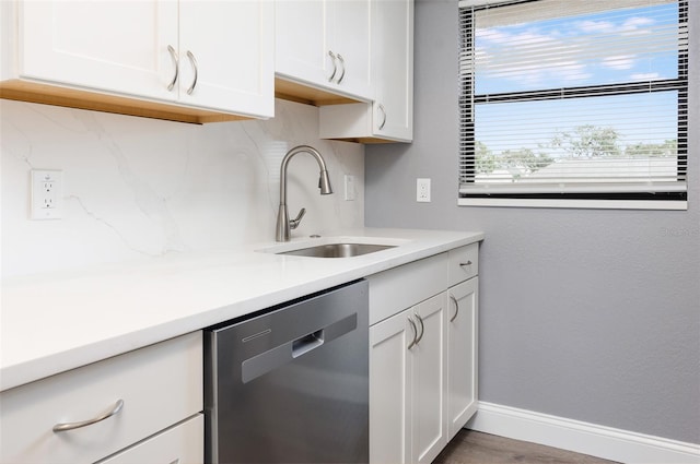 kitchen with dishwasher, white cabinets, and sink