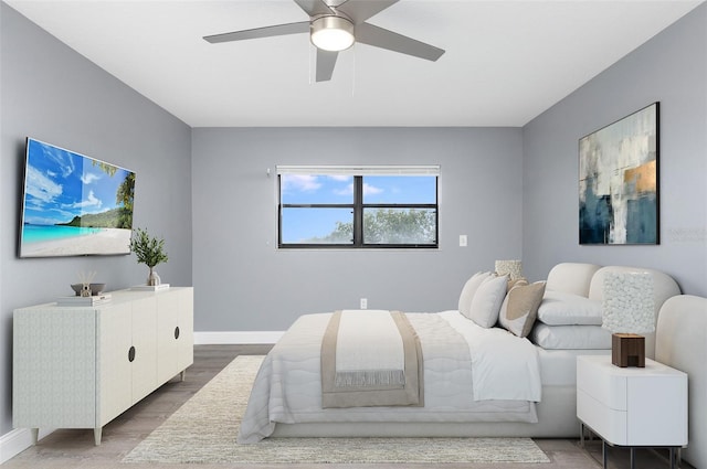 bedroom with ceiling fan and hardwood / wood-style flooring