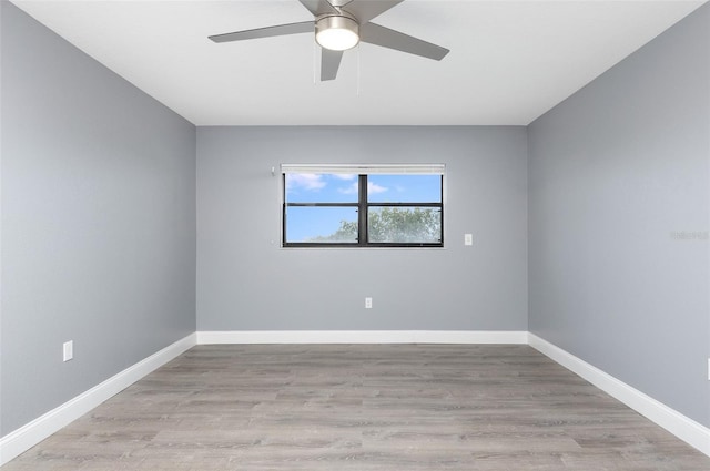 spare room with ceiling fan and light wood-type flooring