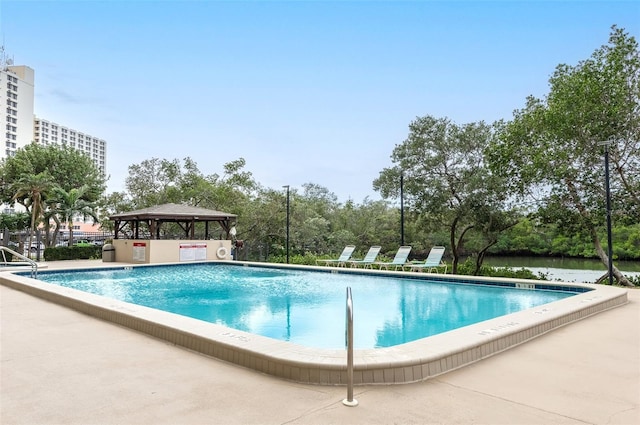 view of swimming pool featuring a water view and a gazebo