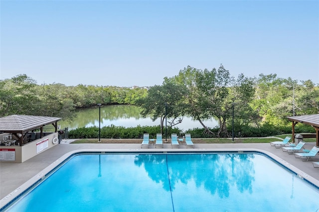 view of swimming pool with a gazebo and a water view