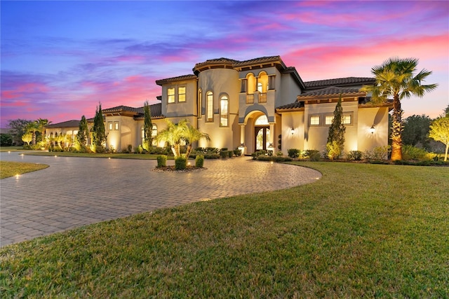 mediterranean / spanish-style house featuring a lawn