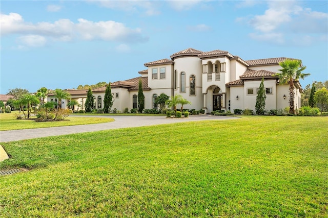 mediterranean / spanish-style home with a front lawn