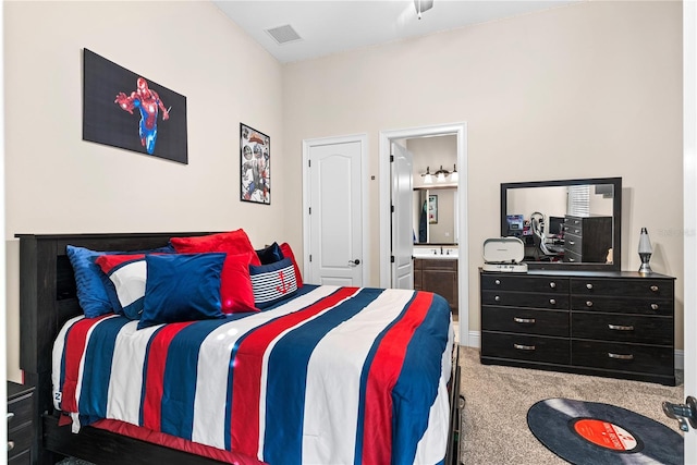 carpeted bedroom featuring ensuite bath