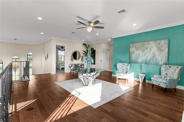 living area featuring ceiling fan, wood-type flooring, and ornamental molding