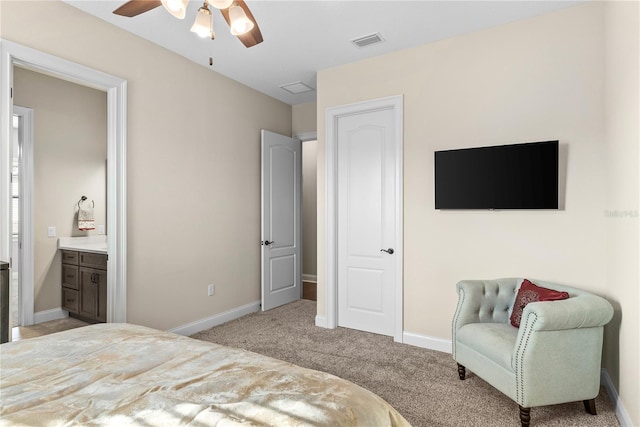 carpeted bedroom with ceiling fan and ensuite bathroom