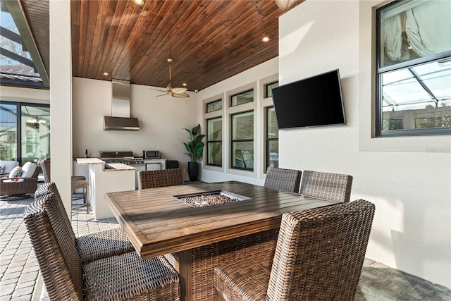 interior space with ceiling fan, an outdoor fire pit, and area for grilling