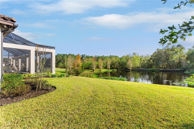 view of yard featuring a lanai and a water view