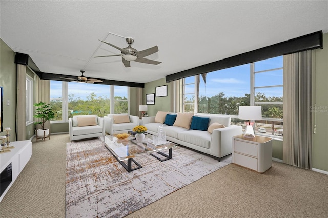 carpeted living room with a textured ceiling and ceiling fan