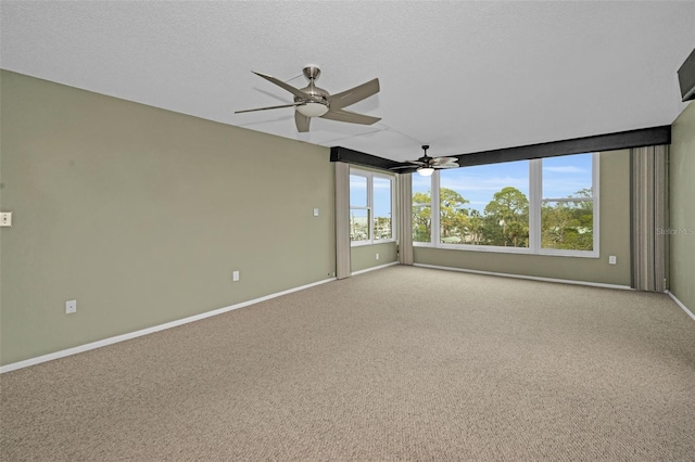 carpeted spare room with a textured ceiling and ceiling fan