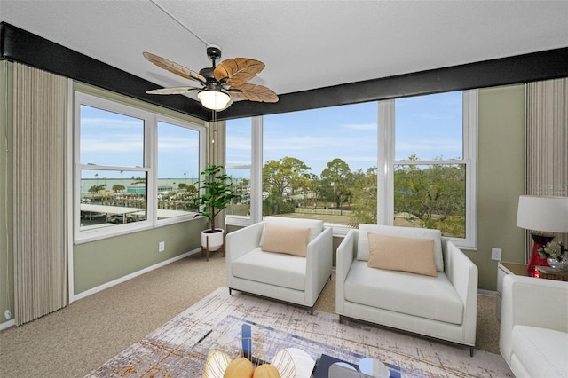 sunroom featuring ceiling fan