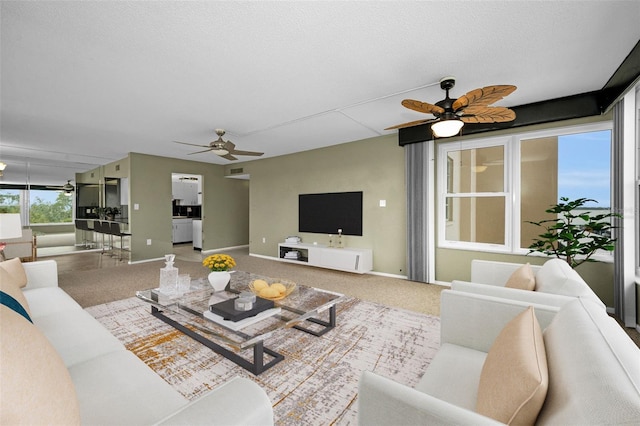 carpeted living room featuring ceiling fan