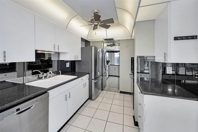 kitchen featuring ceiling fan, sink, light tile patterned flooring, appliances with stainless steel finishes, and white cabinets