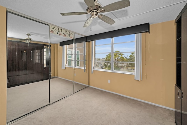 interior space with ceiling fan