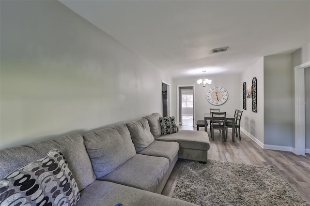 living room with a chandelier and light hardwood / wood-style flooring